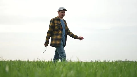 Farmer walks with tablet field checking crop. Farmer uses tablet for farm Stock Footage 315342088