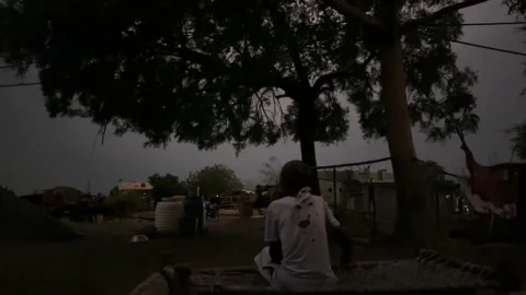 Farmer watching a dramatic lightning storm illuminating the sky Video stock 338047153