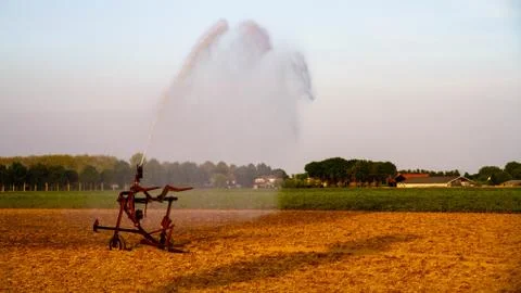 Farmer wetting his fields Stock Photos