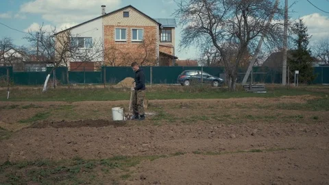 A farmer working in his garden. Stock Footage 89447981