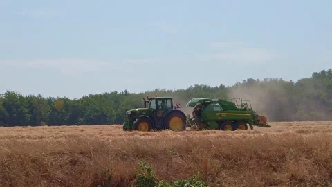 Farmer working in tractor and harvesting crop from the field Stock Footage 201524771
