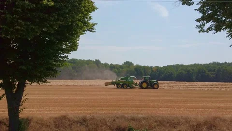Farmer working in tractor and harvesting crop from the field Stock Footage 201524965