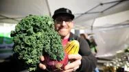 Farmers Market Vendor Lifts Vegetables - Slow Motion Stock Footage