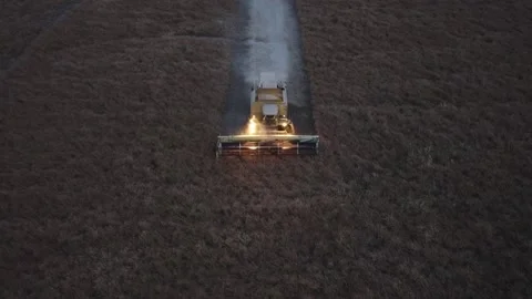 A Farming Combine Threshing Through Crops Stock Footage 139791337
