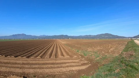 Farming field in spring season. In background small town in Slovenia Stock Footage 128631171