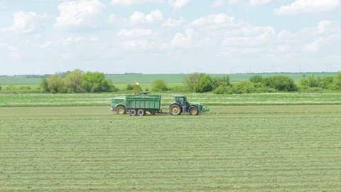 Farming Machine Cultivating Wheat Field Under Clear Sky Bulgaria Agriculture in Stock Footage 310368074