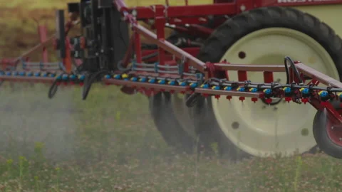Farming tractor spraying on field with sprayer, herbicides and pesticides. Farm Stock Footage 155259994