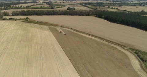 Farming trucks in the distance Stock Footage 124855056