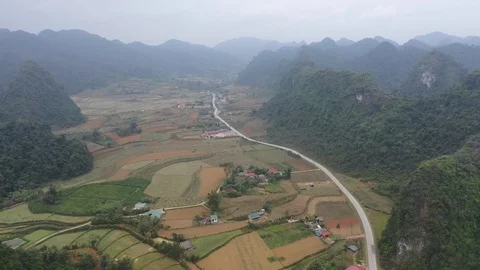 Farming Valley Between Mountains in North Vietnam Aerial Drone Video Stock Footage 125503216