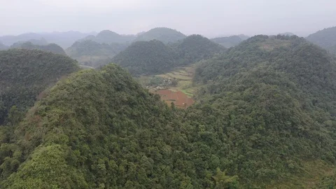 Farming Village Hidden Between Mountains in the North Vietnam Drone Shot Stock Footage 125503189