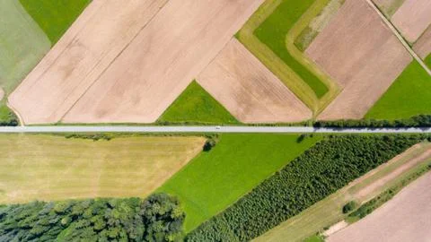 Farmland with road aerial drone top view Stock Photos