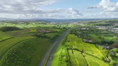 Farms and Fields over Kingskerswell and Road A380 from a drone, Devon, England Stock Footage 274765868