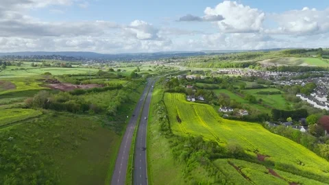 Farms and Fields over Kingskerswell and Road A380 from a drone, Devon, England Stock Footage 274765926