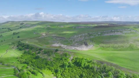 Farms and Mountains over Bainbridge Village, Leyburn, North Yorkshire, England Stock Footage 277304665