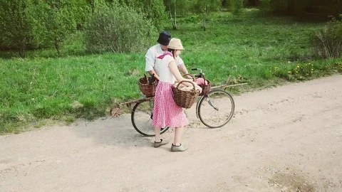 Farms on a bicycle with baskets are on the road. Video stock 113930702