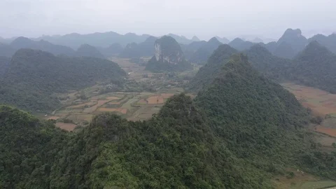 Farms Hidden Behind Towering Mountains in North Vietnam Drone Video Stock Footage 125503115