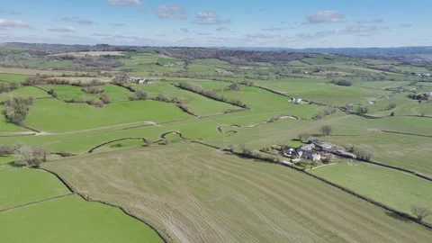 Farms over Corry Brook from a drone, Axminster, Devon, England Video stock 304633365