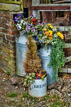Farmyard cotainers with flowers Stock Photos