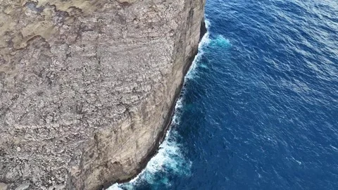 Faroe Islands 4K Drone: Cliffside Glide With Upward Reveal of Rugged Coastline Stock Footage 313497023