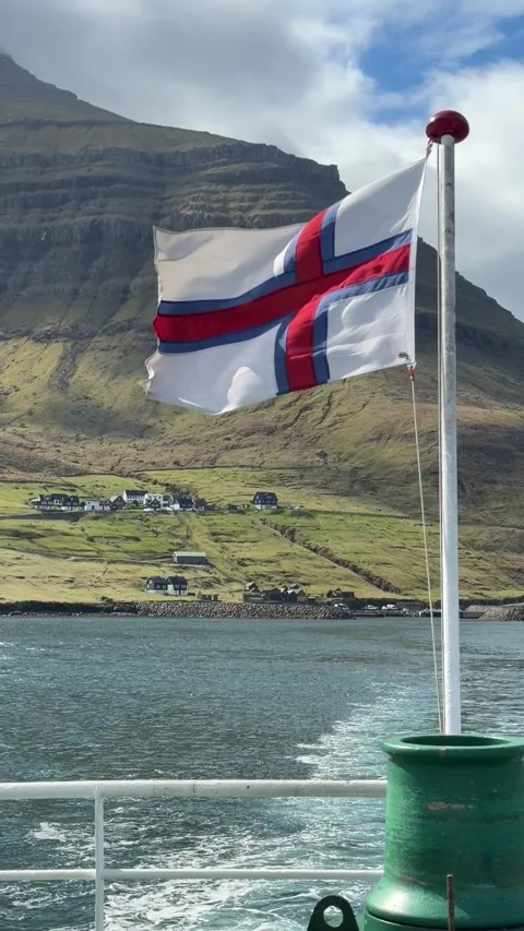 Faroe Islands flag waving in the wind on a moving ferry, North Atlantic Stock Footage 335265432