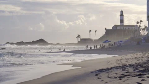 Farol da Barra lighthouse and fortress overlooking sandy beach with ocean waves  Stockbeeldmateriaal 319206867