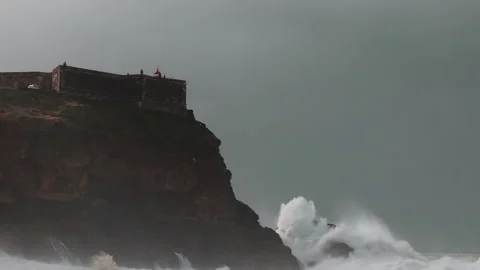 Farol da Nazaré - Lighthouse on the rock. View from north beach Stock Footage 230167787