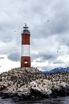 Farol Les Eclaireurs, a red and white striped lighthouse on rocky island on t Stock Photos