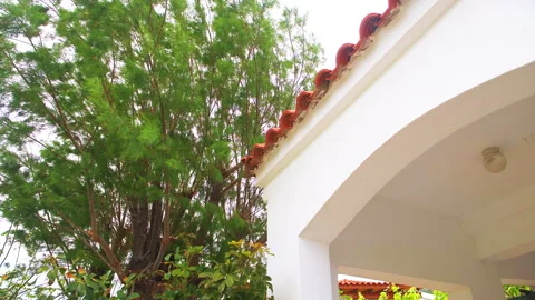 Faros Ikaria island, Greece small fishing village house home roof tile by garden Stock Footage 252157976