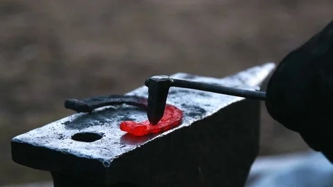 Farrier forges horseshoe in slow motion Stock Footage 77010997
