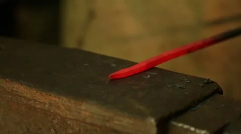 Farrier hammers on the red-hot piece of iron Stock Footage 60641949