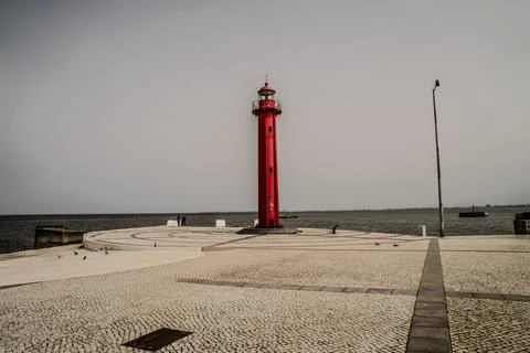 The Farrobo Lighthouse standing tall on a circular paved platform by the Tagu Stock Photos