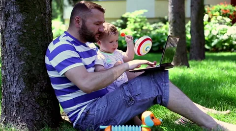 Farther using laptop with son Stock Footage 64946294