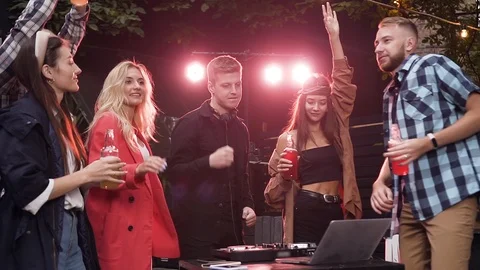 Fascinating cheerful 30s mates dancing under music played by dj on their Stock Footage 116663690