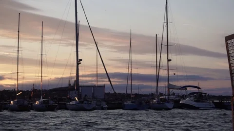 Fascinating low angle panorama view on luxury yacht silhouettes in warm orange Stock Footage 92919658