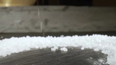 Fascinating probelens super closeup macro dolly shot of salt on black stone Stock Footage 153058965