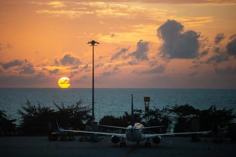 Fascinating View Of Sunset Behind The Air Plane on the Airport in Thailand Stock Photos