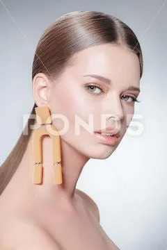 Fashion beauty portrait. Attractive fashion model posing in earrings in the Stock Photos