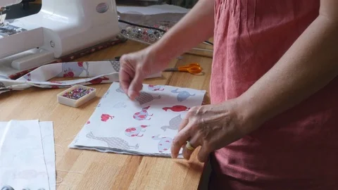 Fashion designer adding fabric to bag design by pinning it Stock-Footage 77232182