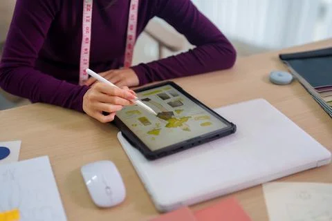 Fashion designer using digital tablet with stylus pen for creative design wor Stock Photos