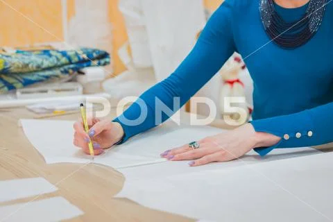 Fashion designer working with pattern of new couture collection Stock Photos