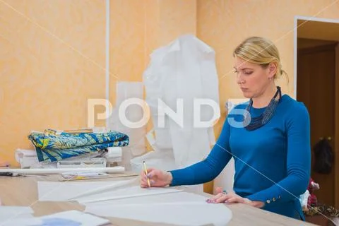 Fashion designer working with pattern of new couture collection Stock Photos