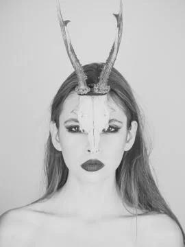 Fashion devil of mystic shaman girl with horns. Woman with makeup and antlers Stock Photos