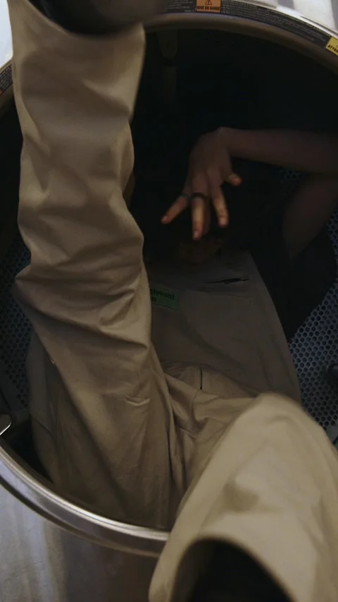 Fashion-Forward Model Strikes a Pose in Laundromat, Showcasing Urban Style with Stock Footage 267079010