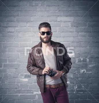 Fashion model in front of brick urban wall Stock Photos