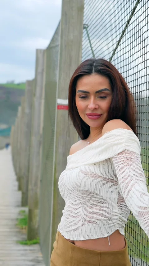 Fashion model posing by a fence in various angles Stock Footage 308010739