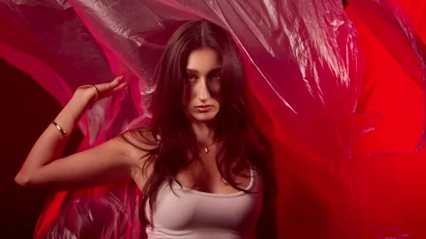 Fashion model posing with flowing red fabric in studio, beauty and art concept, Stock Footage 337004085