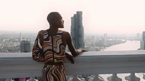 Fashion Model Posing In Swirled Pattern Clothes Looking Over City Video stock 172383803