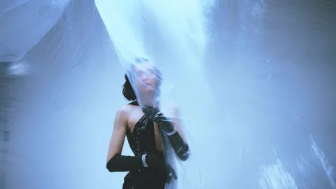 Fashion model posing in white studio walking with transparent film wind blowing Stock Footage 310324566