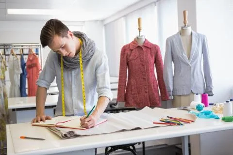Fashion student taking notes on notebook Stock Photos