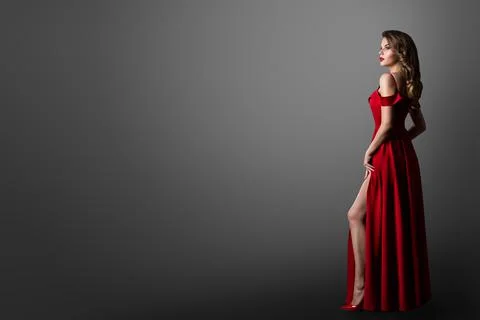 Fashion Woman in Long Red Dress. Model Showing Leg in Evening Silk Slit Gown. Stock Photos